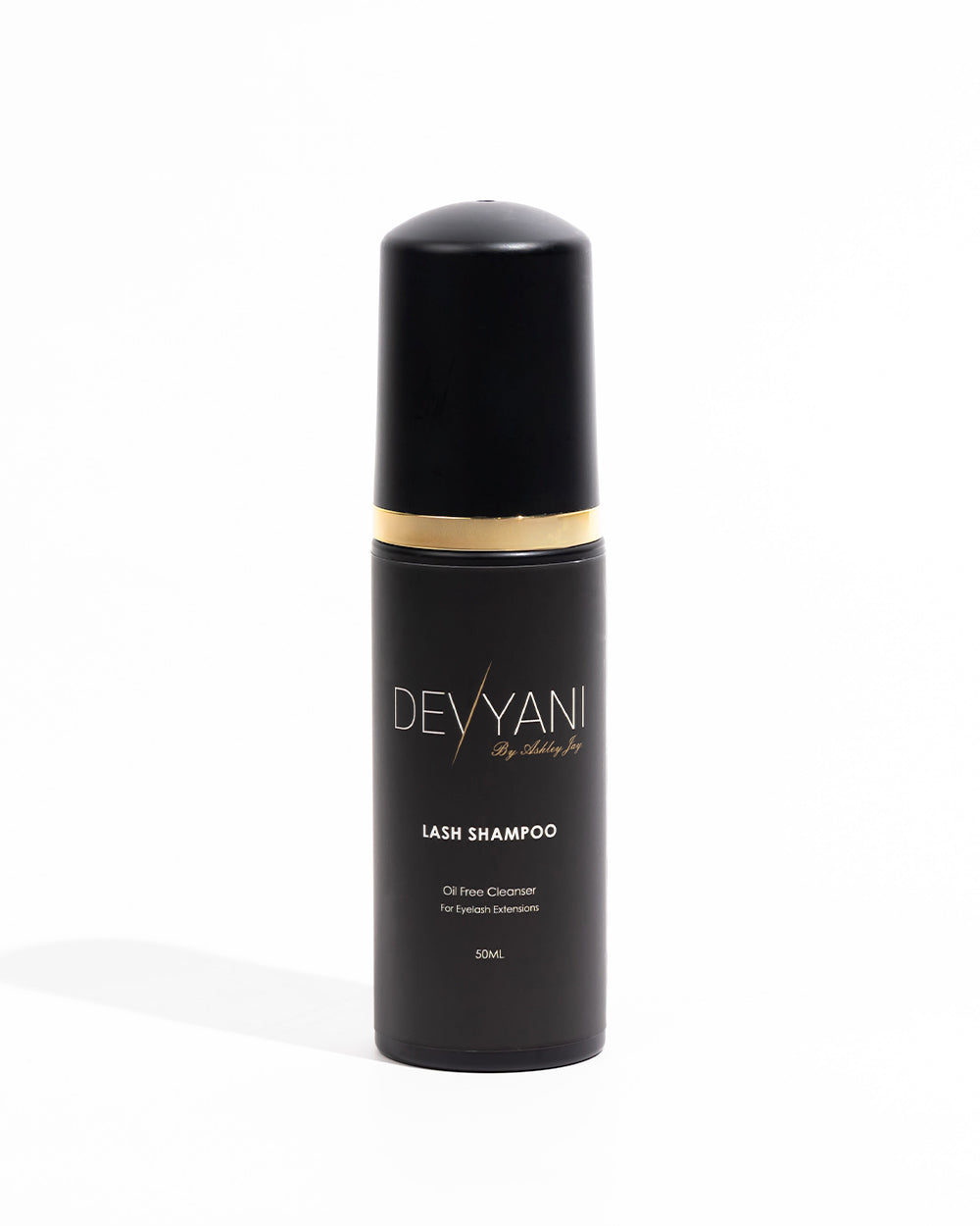 Black shampoo bottle with gold accent and 'DEVYANI' branding on a white background