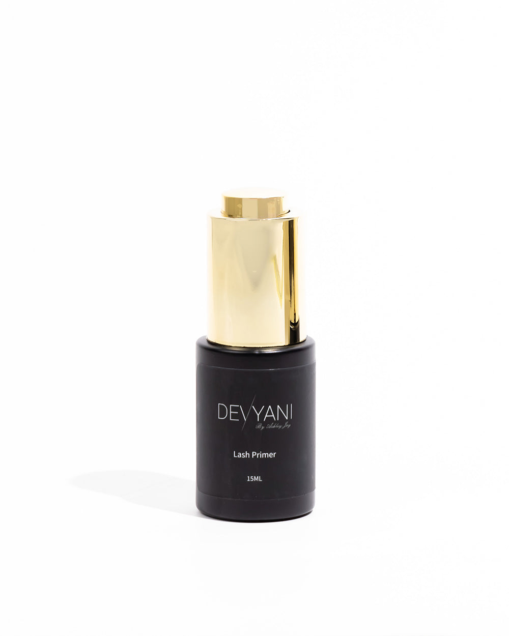 Black and gold Devyani lash primer bottle on a white background