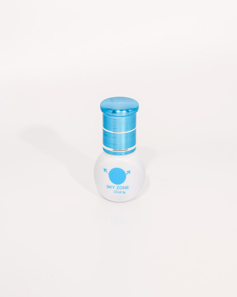 White bottle with blue cap on a white background